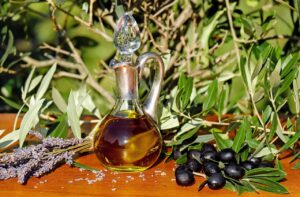 Olive oil bottle with fresh olives